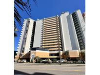 Beautiful exterior of a condo building with a blue sky background and street access to shopping and restaurants at 2710 N Ocean Blvd. # 1038, Myrtle Beach, SC 29577