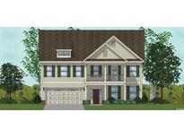 Charming two-story home with a covered front porch and lush landscaping, showcasing classic architectural details at 4008 Bucolic Loop, Myrtle Beach, SC 29588