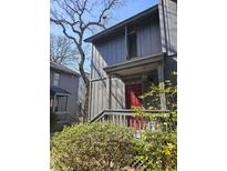 Gray two-story townhouse featuring a red front door and mature landscaping at 404 71St Ave. N # 709, Myrtle Beach, SC 29572