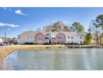 Charming brick and beige two-story home with a peaceful pond view, perfect for relaxation at 4283 Santolina Way # H, Murrells Inlet, SC 29576