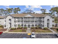 Well-maintained condo complex with multiple units, manicured landscaping, and convenient parking at 4430 Eastport Blvd. # L5, Little River, SC 29566