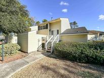 Charming two-story home with light yellow siding, neat landscaping, and a welcoming front entrance at 488 Greenview Dr. # 1, Johnsonville, SC 29555