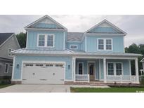 Charming light blue two-story home featuring a front porch and a two-car garage at 5023 Middleton View Dr., Myrtle Beach, SC 29579