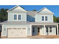 Charming two-story home featuring light blue siding, a two-car garage, and covered front porch at 5023 Middleton View Dr., Myrtle Beach, SC 29579