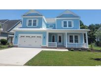 Charming two-story home features a light blue exterior, white trim, front porch, and well-manicured lawn at 5023 Middleton View Dr., Myrtle Beach, SC 29579