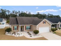 Charming single-story home with well-manicured landscaping and attached garage at 545 Tourmaline Dr., Little River, SC 29566