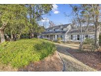 Traditional two-story home with light blue siding, shutters, and a landscaped yard at 5704 Woodside Ave., Myrtle Beach, SC 29577