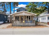 Charming beach cottage with a cozy front porch and wood railings at 6001- 1688 S Kings Highway, Myrtle Beach, SC 29575