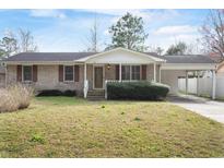Charming single-story brick home featuring a covered carport and well-maintained front yard at 616 Mckinley Way, Conway, SC 29526