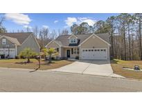 Charming single-story home featuring a well-manicured lawn and attached two-car garage at 108 Silver Peak Dr., Conway, SC 29526