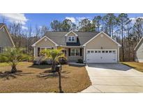 Charming single-story home with a well-manicured lawn and an attached two-car garage at 108 Silver Peak Dr., Conway, SC 29526