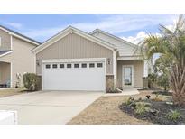 Charming home featuring a two-car garage, inviting curb appeal, and well-maintained landscaping at 1097 Balmore Dr., Myrtle Beach, SC 29579