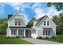 Charming home with light blue siding, black roof, and inviting front porch at 115 S Middleton Dr. Nw, Calabash, NC 28467