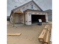 Exterior shot of an unfinished home with a garage and a porch at 1241 Lady Bird Way, North Myrtle Beach, SC 29582
