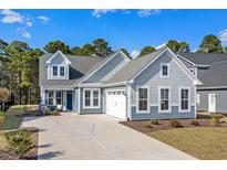 Charming two-story home with a two-car garage, well-maintained landscaping and a welcoming entryway at 136 Starlit Way, Myrtle Beach, SC 29579