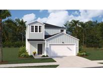Charming two-story home with light blue siding, a two-car garage, and a well-manicured lawn at 1369 Palm Springs Paloma Dr, Longs, SC 29568