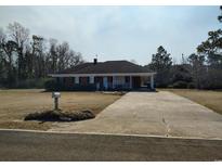 Charming single-story brick home with a covered porch and long driveway at 1375 Kenny Jordan Rd, Tabor City, NC 28463