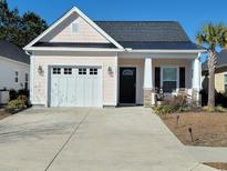 Charming single-story home with a well-manicured lawn and a two-car garage at 1501 Ferney Dr., Conway, SC 29526