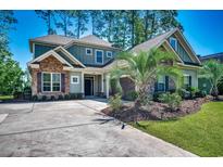 Beautiful two-story home with stone accents, manicured landscaping, and a spacious concrete driveway at 2131 Timmerman Rd., Myrtle Beach, SC 29588