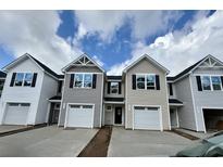 New two-story townhomes featuring attached garages and contemporary architecture under a partly cloudy sky at 262 Christiana Ln. # C, Myrtle Beach, SC 29579