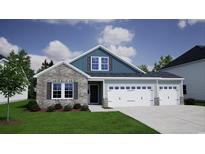 Charming two-story home featuring stone accents, a two-car garage, and a well-manicured front lawn at 309 Mayflower Dr., Calabash, NC 28467