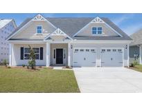 Charming two-story home with a two car garage, landscaped yard, and welcoming front porch at 4028 Bucolic Loop, Myrtle Beach, SC 29588