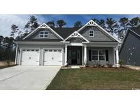 Charming single-Gathering home featuring a two-car garage and well-maintained front lawn at 4028 Bucolic Loop, Myrtle Beach, SC 29588