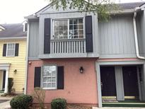 Charming condo with a gray and salmon exterior, complemented by black shutters and lush greenery at 501 44Th Ave. N # A-11, Myrtle Beach, SC 29577