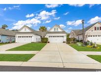 Charming single-story home featuring a two-car garage, manicured lawn, and beautiful landscaping at 6069 Tramonto St., Myrtle Beach, SC 29572