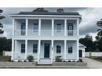 Stunning two-story home with double balconies, columns, and neatly landscaped yard exudes Southern charm at 8053 Laurel Ash Ave., Myrtle Beach, SC 29572