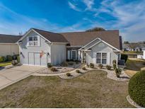 Charming single-Gathering home boasts a two-car garage, manicured lawn, and quaint landscaping at 807 Lalton Dr., Conway, SC 29526