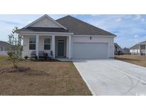 Charming one-story home featuring a well-manicured lawn and an attached garage at 1460 Porchfield Dr., Conway, SC 29526