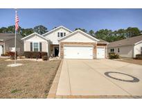 Charming single-story home featuring a spacious driveway and attached two-car garage at 161 Copper Leaf Dr., Myrtle Beach, SC 29588