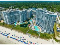 Stunning aerial view of beachfront resort with multiple pools and ocean access at 161 Seawatch Dr. # 808, Myrtle Beach, SC 29572