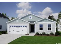 Charming single-story home with a two-car garage and manicured front lawn under a bright, cloudy sky at 308 Mayflower Dr., Calabash, NC 28467