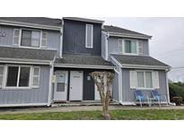 Inviting multi-story condo building featuring neutral siding, well-maintained landscape, and covered entrances at 3700 Golf Colony Lane # 10C, Little River, SC 29566