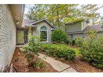 Charming home with a well-manicured front yard and a welcoming entrance at 409 65Th Ave. N, Myrtle Beach, SC 29572