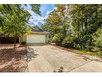 Charming single-story home featuring a brick exterior, lush landscaping, and a two-car garage at 409 65Th Ave. N, Myrtle Beach, SC 29572