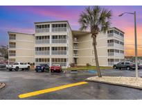 Three-story condo building featuring screened balconies and ample parking at 4350 Intercoastal Dr. # 1404, Little River, SC 29566