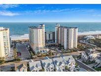 Expansive aerial view of a beachfront condo building with beautiful ocean views and surrounding neighborhood at 5200 N Ocean Blvd. # 937, Myrtle Beach, SC 29577