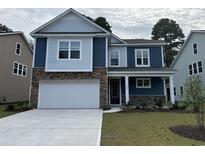 Charming two-story home features a two-car garage, stone accents, and welcoming front porch at 539 Slaty Dr., Myrtle Beach, SC 29588
