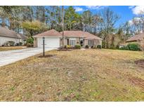 Charming single-story home with a well-manicured lawn and attached two-car garage at 540 Alderly Ct., Little River, SC 29566