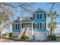 Charming two-story beach house with a welcoming front porch and well-maintained landscaping at 728 Elizabeth Dr., Murrells Inlet, SC 29576