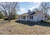 Charming single-story home with a covered porch, black shutters, and a well-maintained yard at 822 Highway 90, Conway, SC 29526