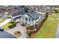 Beautiful two-story home featuring double porches, mature landscaping, and a circular driveway at 898 Bluffview Dr., Myrtle Beach, SC 29579