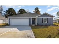 Charming one-story home featuring a gray exterior, attached garage, and a well-manicured lawn at 906 Ireland Dr., Longs, SC 29568