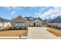 Beautiful brick home featuring a well-manicured lawn and inviting curb appeal at 931 Henry James Dr., Myrtle Beach, SC 29579