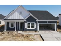 Charming single-story home with blue siding, white trim, and an attached two-car garage at 1013 Jase Dr., Longs, SC 29568