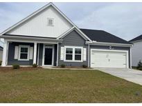 Charming single-story home with a well-manicured lawn, attached garage, and a welcoming front entrance at 1013 Jase Dr., Longs, SC 29568