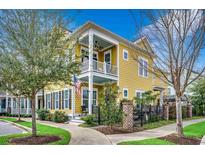 Charming yellow two-story home with double porches and a well-manicured lawn and walkway at 1045 Means Circle, Myrtle Beach, SC 29577